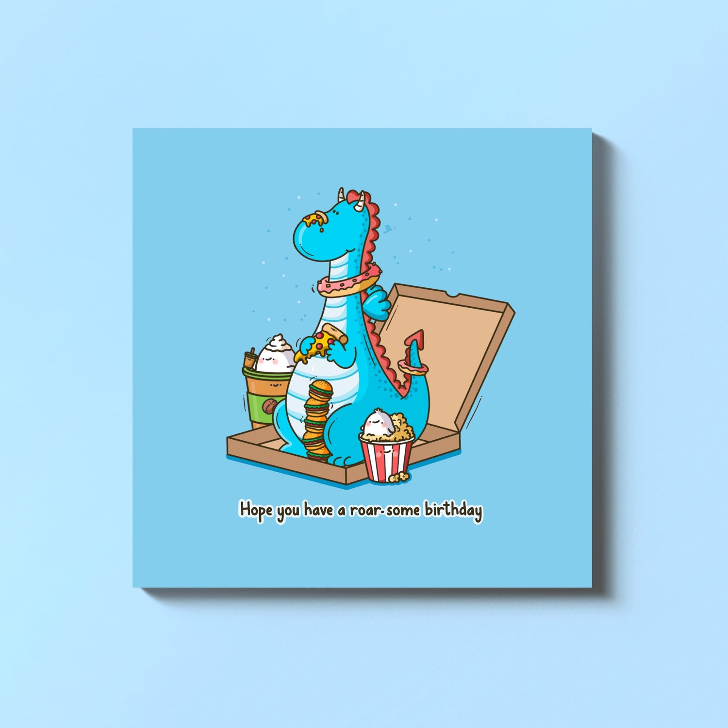 Dragon birthday card on blue table