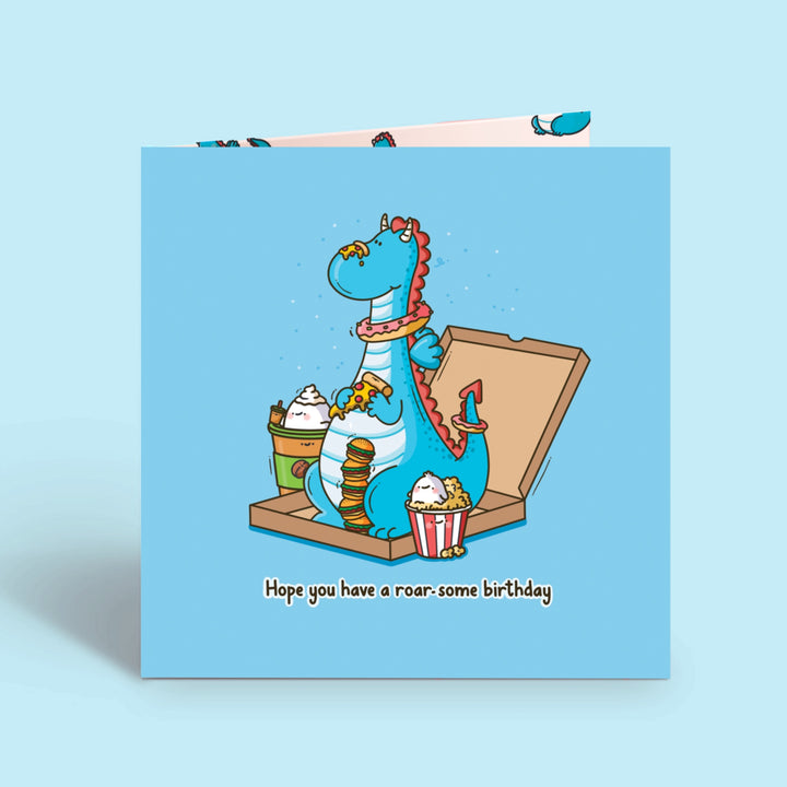 Dragon birthday card on blue table