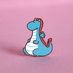 Dragon enamel pin on pink table