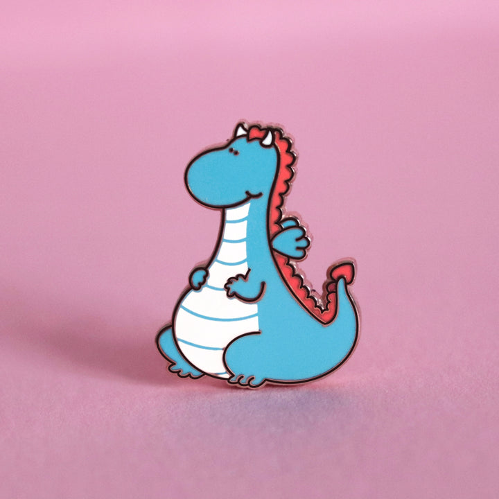 Dragon enamel pin on pink table