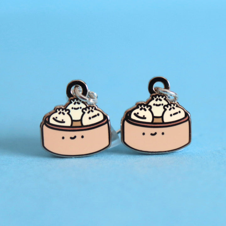 Dumpling earrings on blue desk