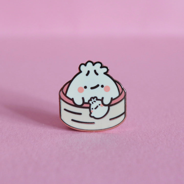 Dumpling enamel pin on pink table