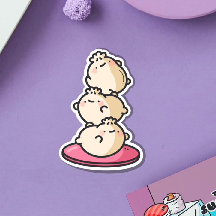 Dumpling stack vinyl sticker on purple table