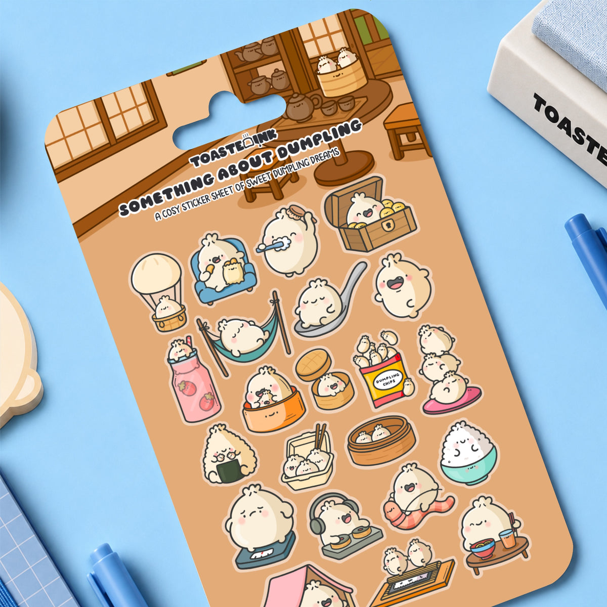 Dumpling sticker sheet on blue desk with stationery