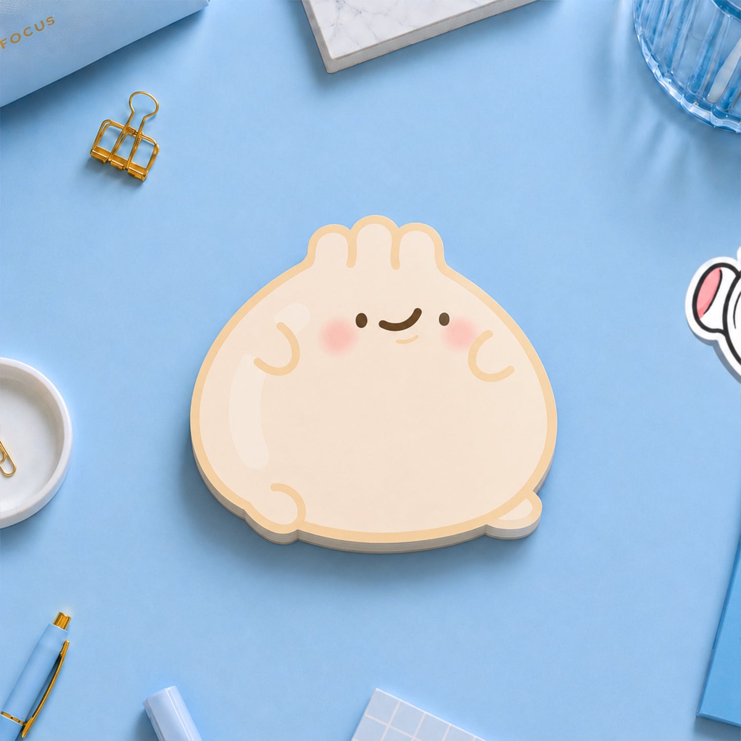 Dumpling shaped sticky notes on blue desk