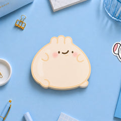 Dumpling shaped sticky notes on blue desk