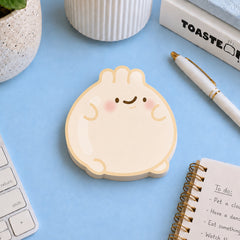 Dumpling sticky notes on blue desk with stationery