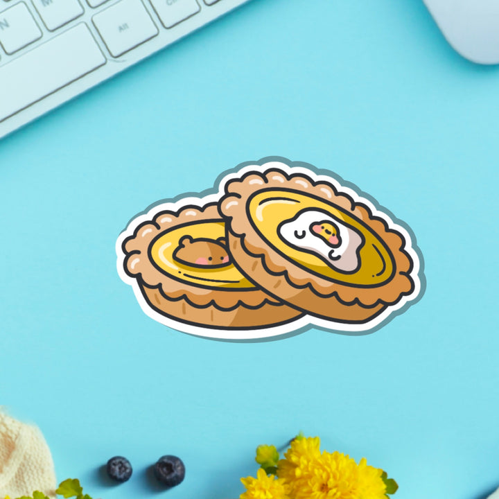 Egg tart vinyl sticker on blue table with keyboard