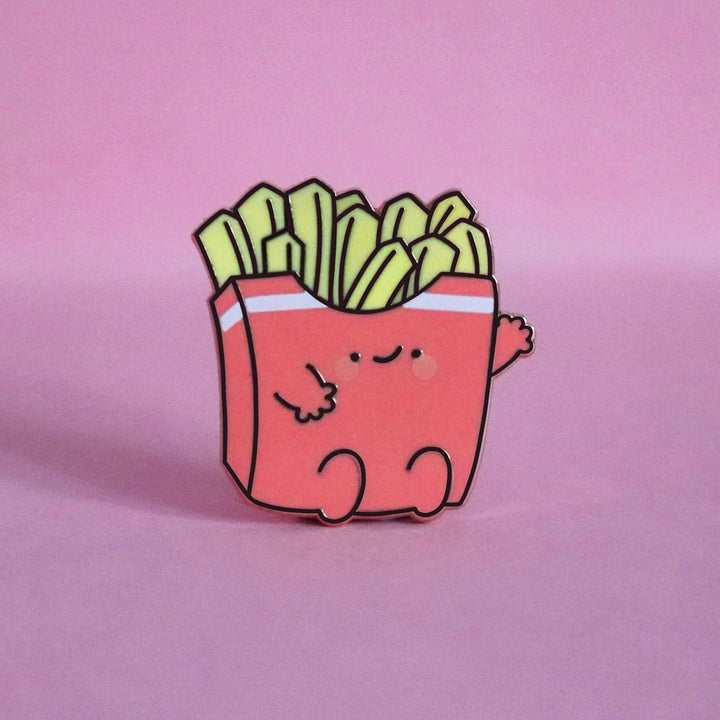 French fries enamel pin on pink table