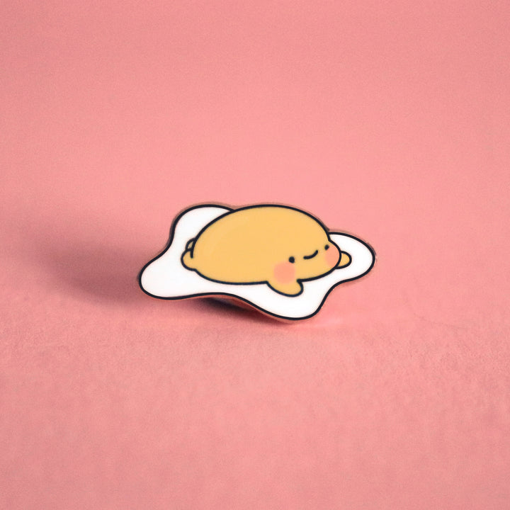 Fried egg enamel pin on pink table