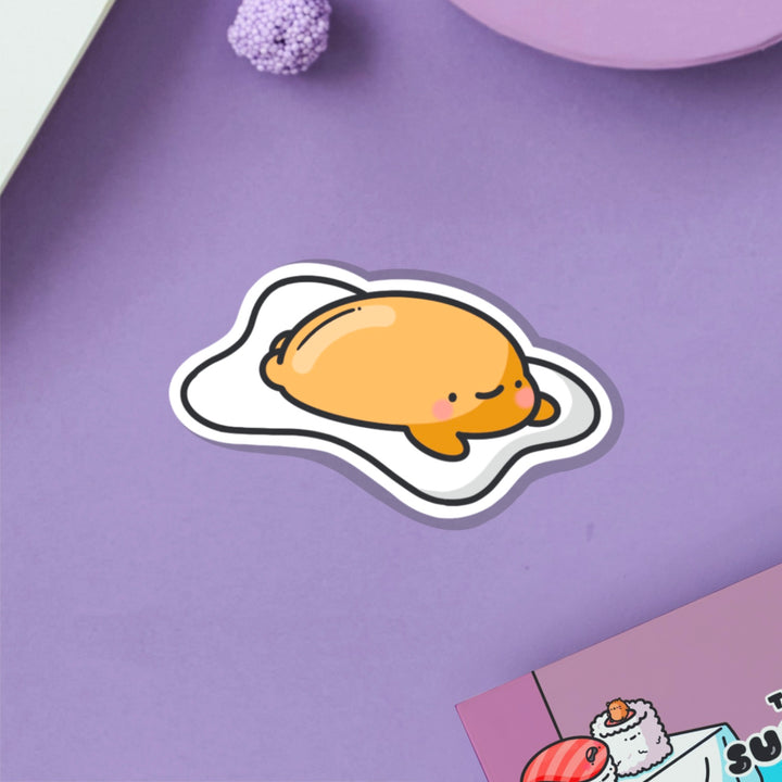 Fried egg vinyl sticker on purple table