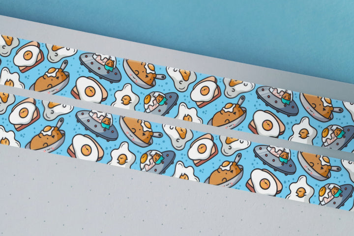 Fried egg washi tape on blue desk with notebook