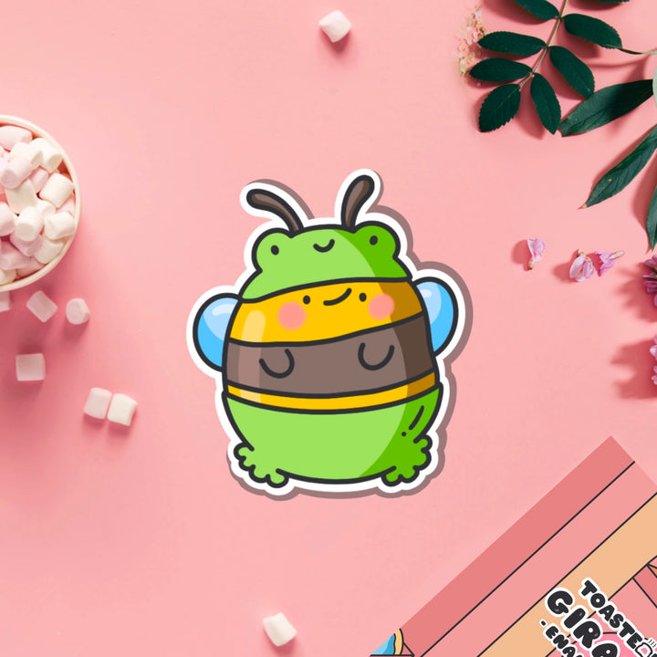 Bee dressed as frog vinyl sticker on pink table