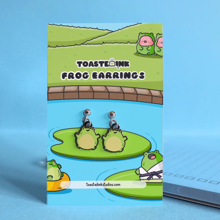 Frog stud earrings on backing card