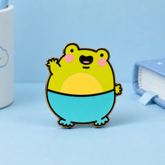 Frog Enamel Pin on blue table