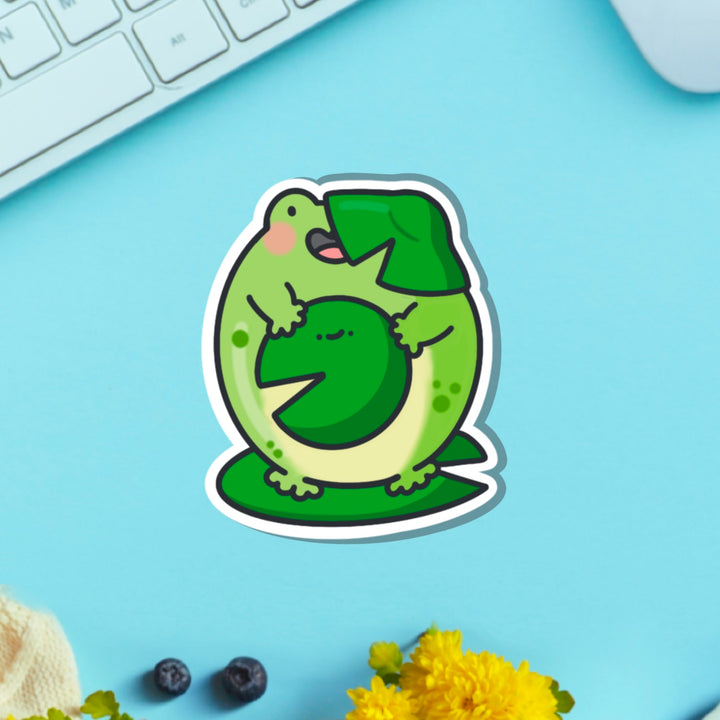 Frog on a lily vinyl sticker on blue table with keyboard