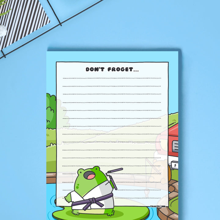 A6 frog notepad on blue table close up