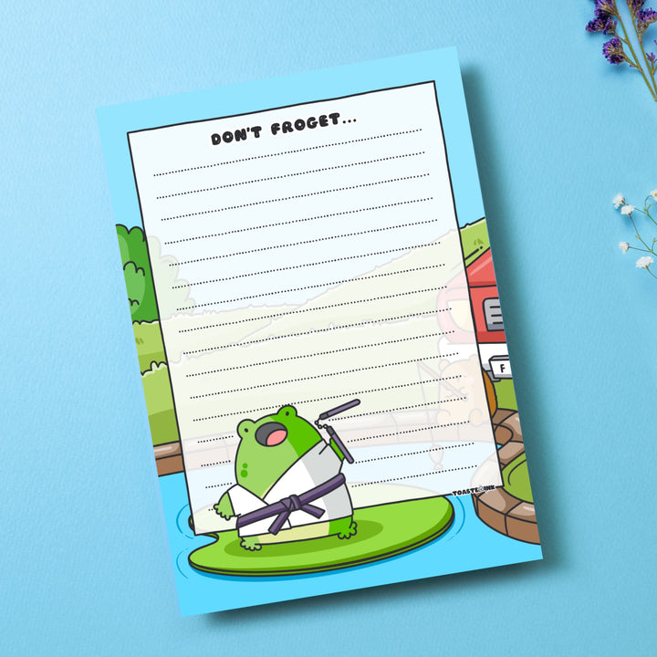 A6 frog notepad on blue table with flowers