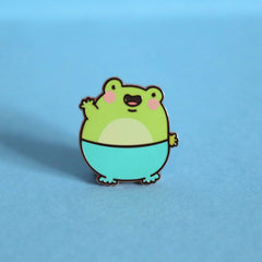 Frog enamel pin on blue background