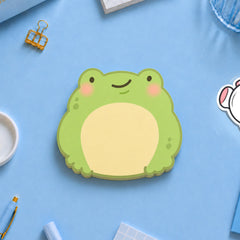 Frog sticky notes pad on blue table with stationery