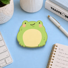 Frog shaped sticky notes on blue desk with stationery