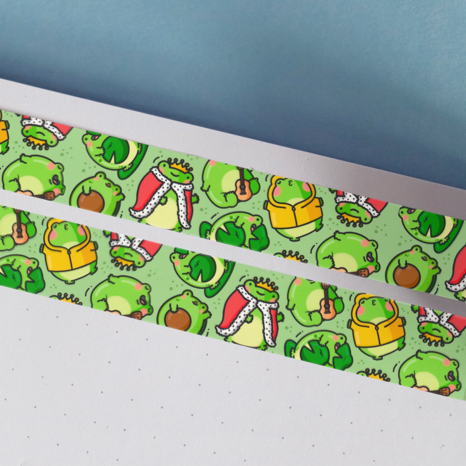 Green frog washi tape on notebook and blue table