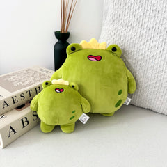Big frog and frog keychain plush on white table with cushion