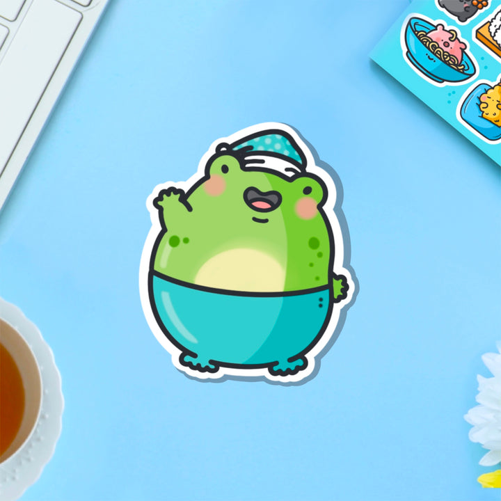 Frog in pyjamas vinyl sticker on blue table