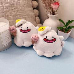 Two matching ghost plush keychains with kawaii ice cream and egg hats
