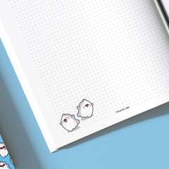 Close up ghosts on dot grid notebook
