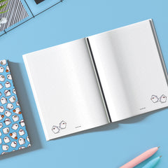 Ghosts on dot grid notebook on blue table