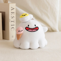 Ghost keychain plush with fried egg and ice cream on beige background