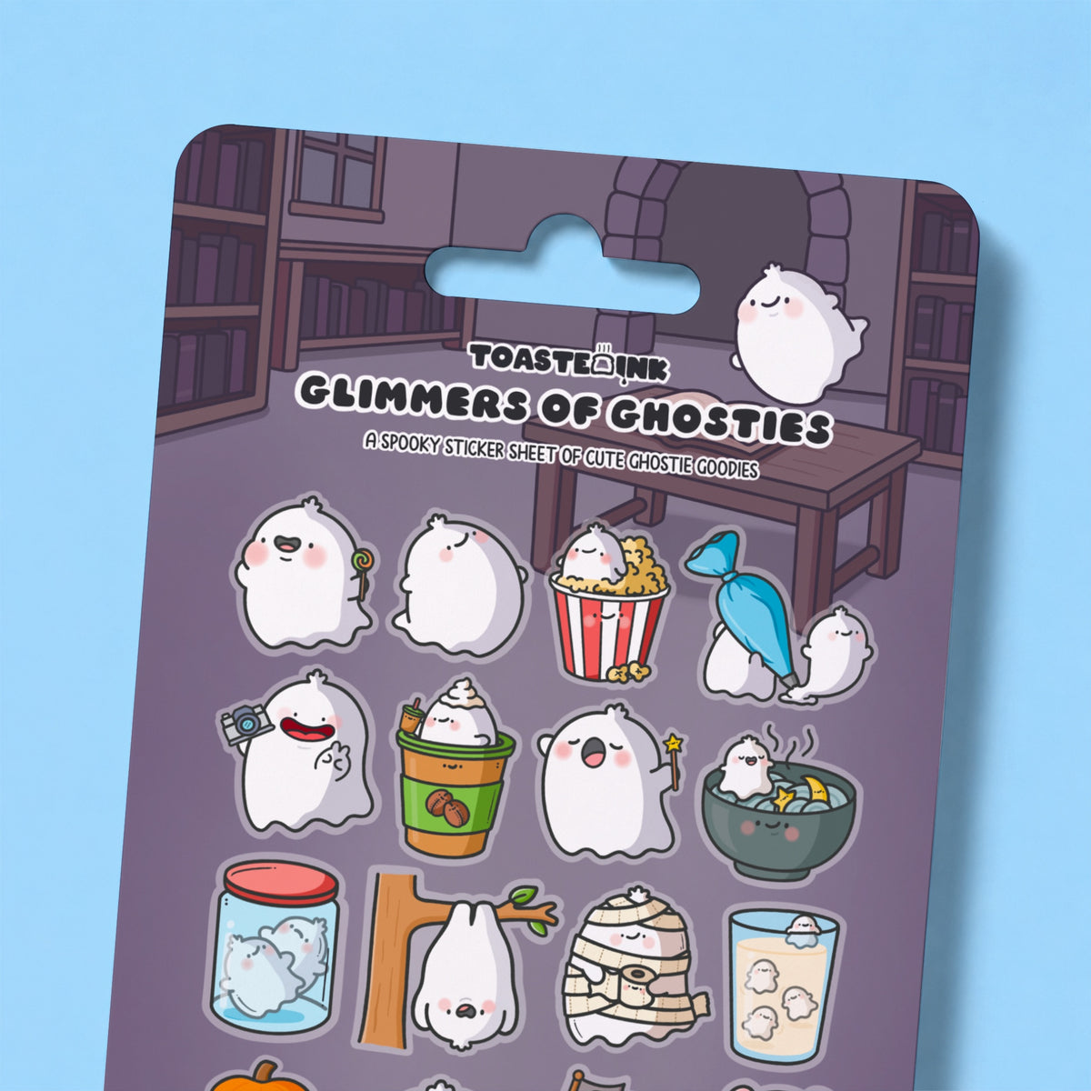 Close up of whimsical ghost sticker sheet on blue desk