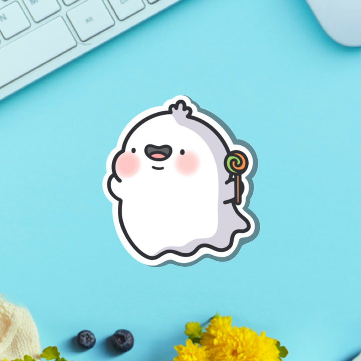 Ghost with lollipop vinyl sticker on green table