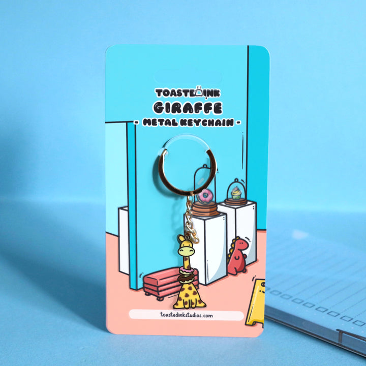 giraffe keychain backing card on blue table