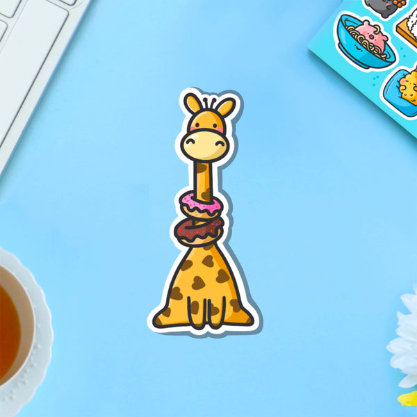 Giraffe wearing donuts vinyl sticker on blue table