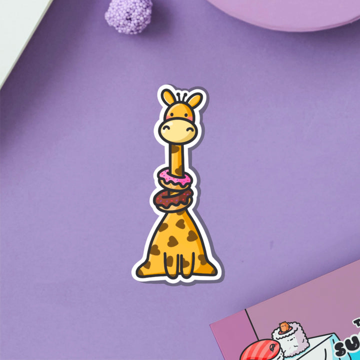 Giraffe wearing donuts vinyl sticker on purple table