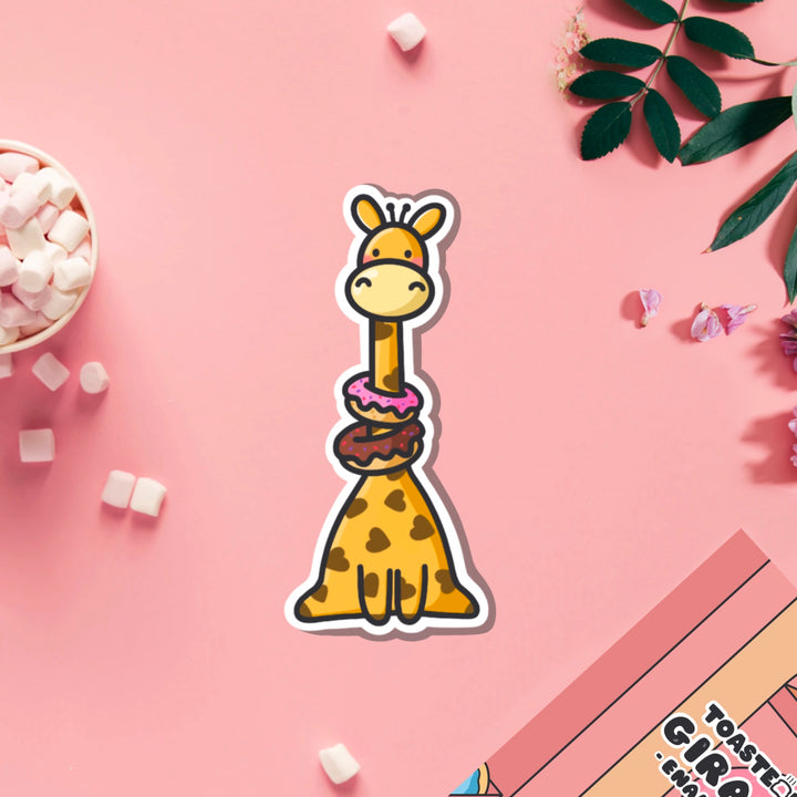 Giraffe wearing donuts vinyl sticker on pink table