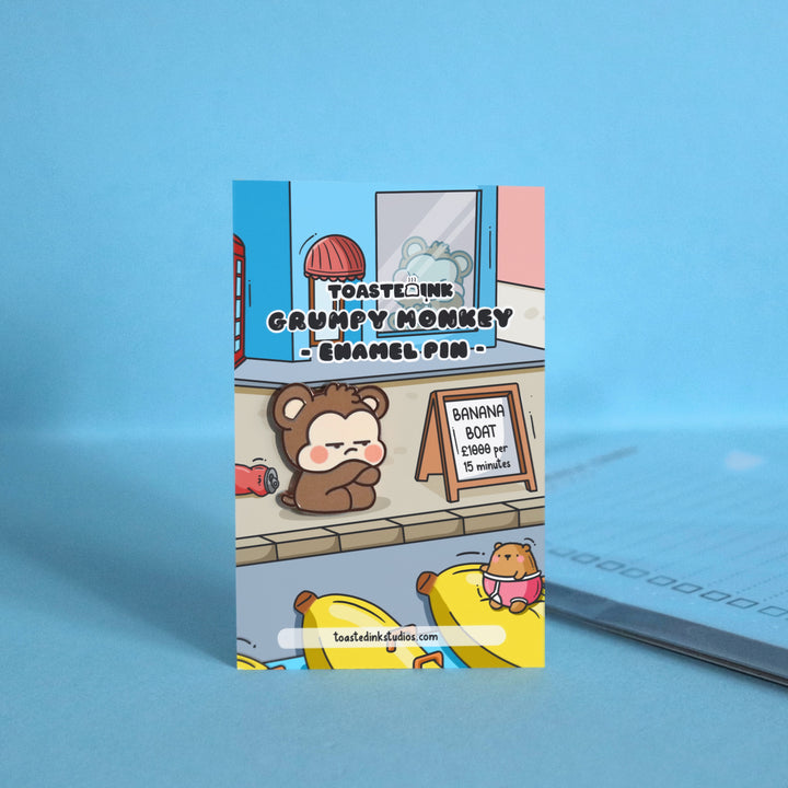 Grumpy monkey enamel pin on backing card