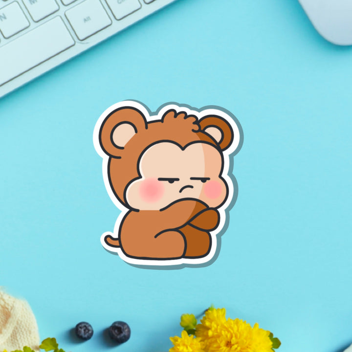 Grumpy Monkey vinyl sticker on green table