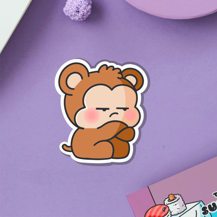 Grumpy Monkey vinyl sticker on purple table