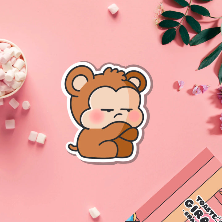 Grumpy Monkey vinyl sticker on pink table