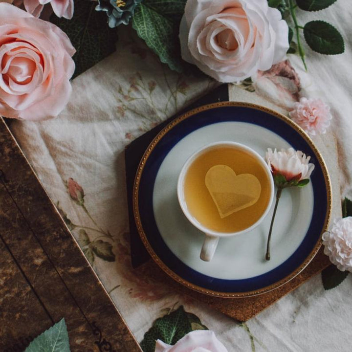 Heart shaped tea bags in mug with flowers