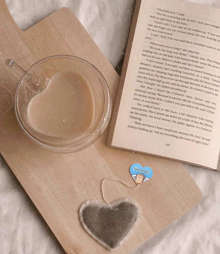 Heart shaped tea bag with book and mug