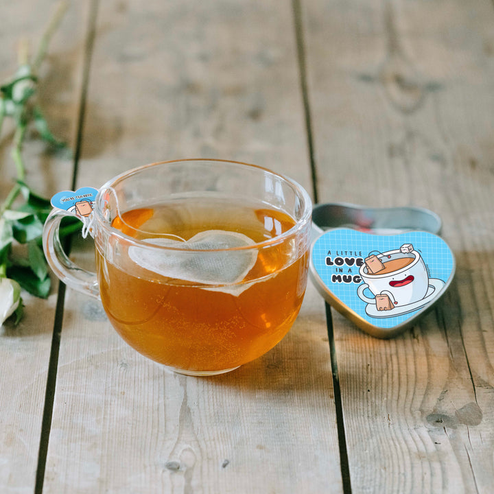 Heart shaped tea bag in clear mug