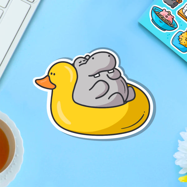 Hippo in rubber duck dinghy vinyl sticker on blue table