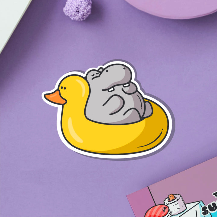 Hippo in rubber duck dinghy vinyl sticker on purple table