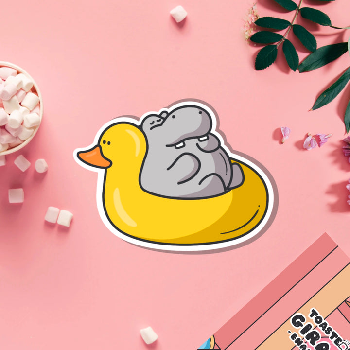 Hippo in rubber duck dinghy vinyl sticker on pink table