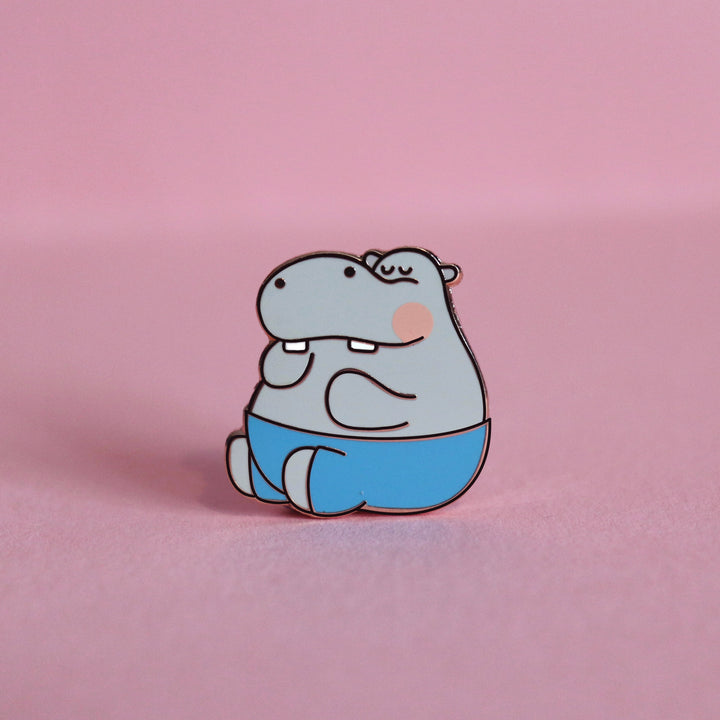 Hippo enamel pin on pink desk