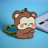 Gold Monkey keychain on blue table